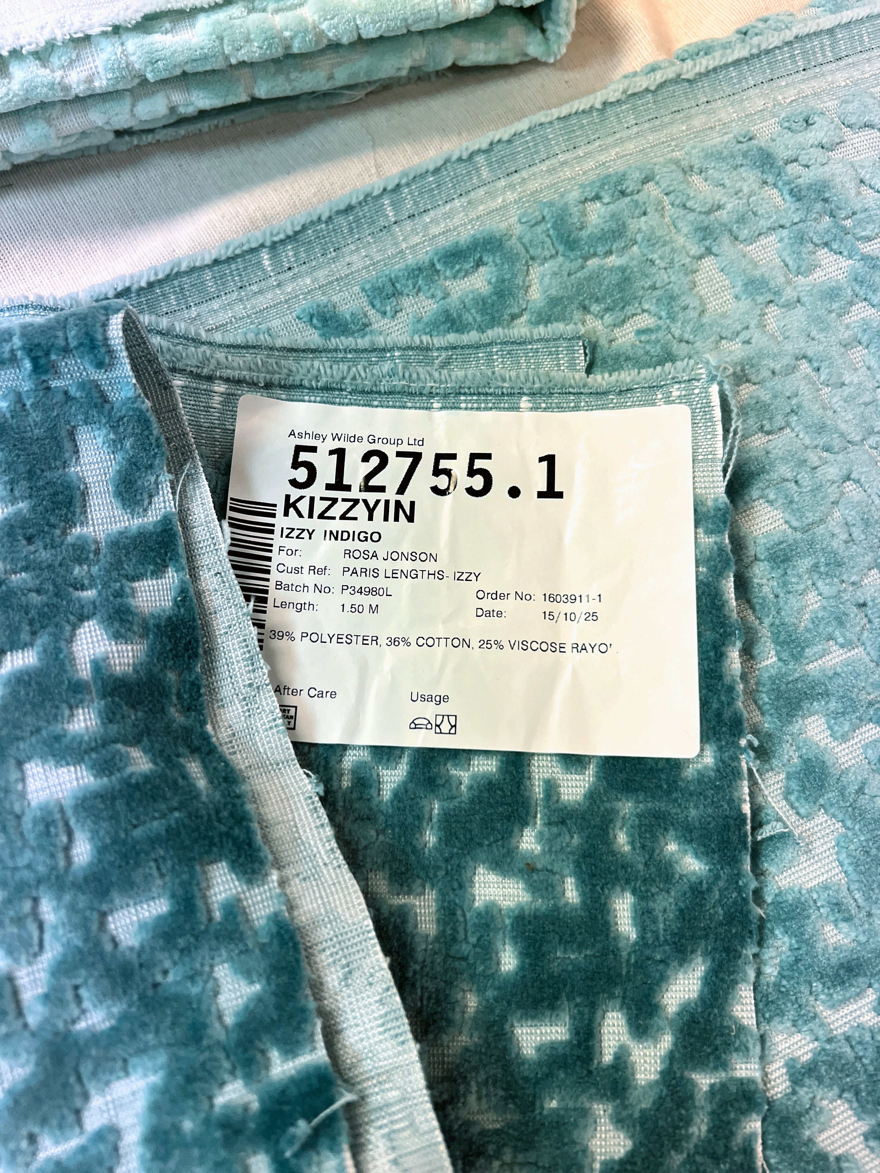 Close-up of a fabric with a label displaying a product code and brand name.